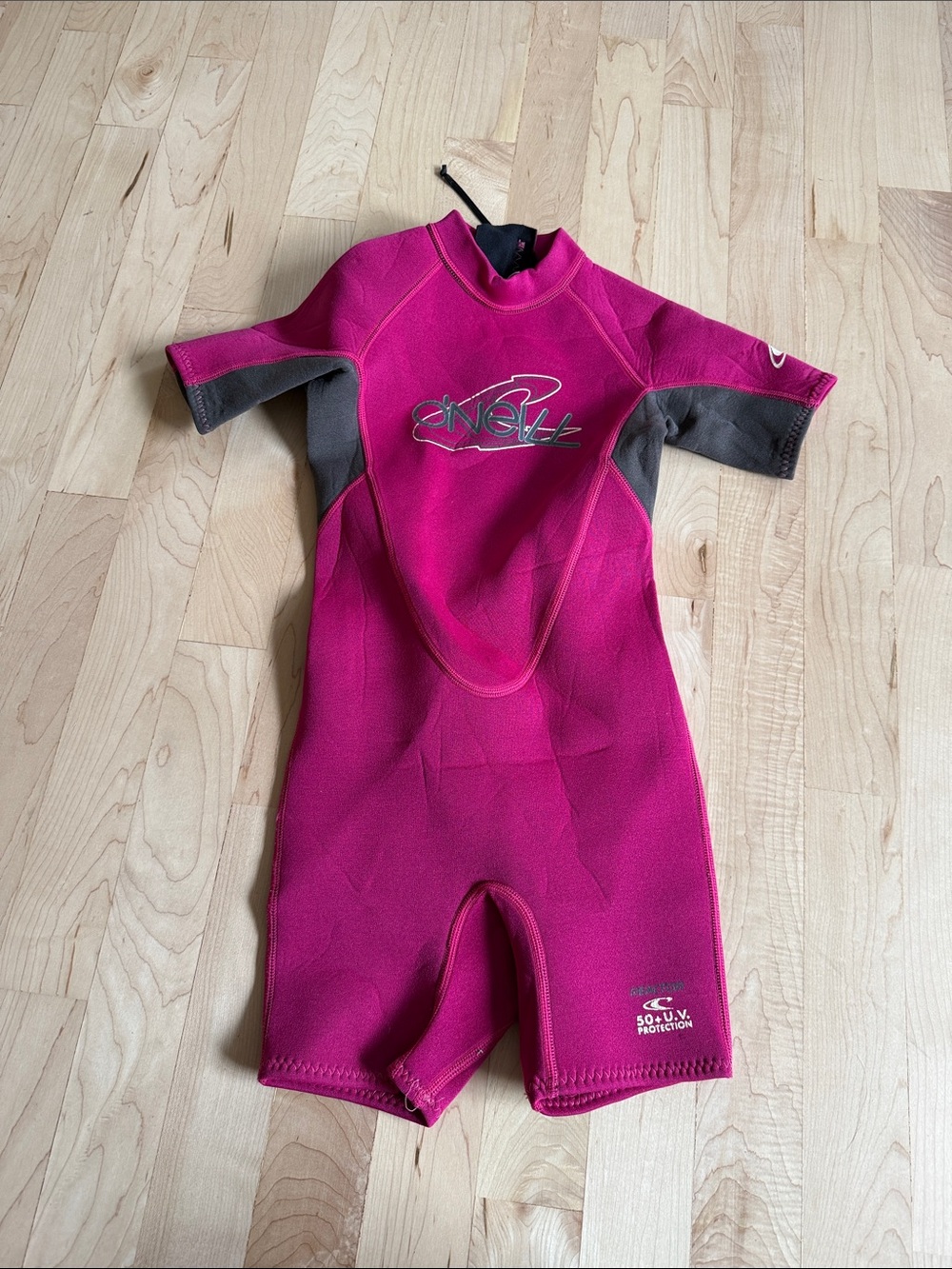 O'Neill Kids Hot Pink and Gray Shorty wetsuit.